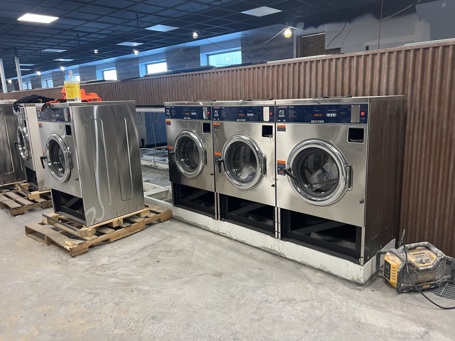 The finished coinless laundry with rows of commercial washers