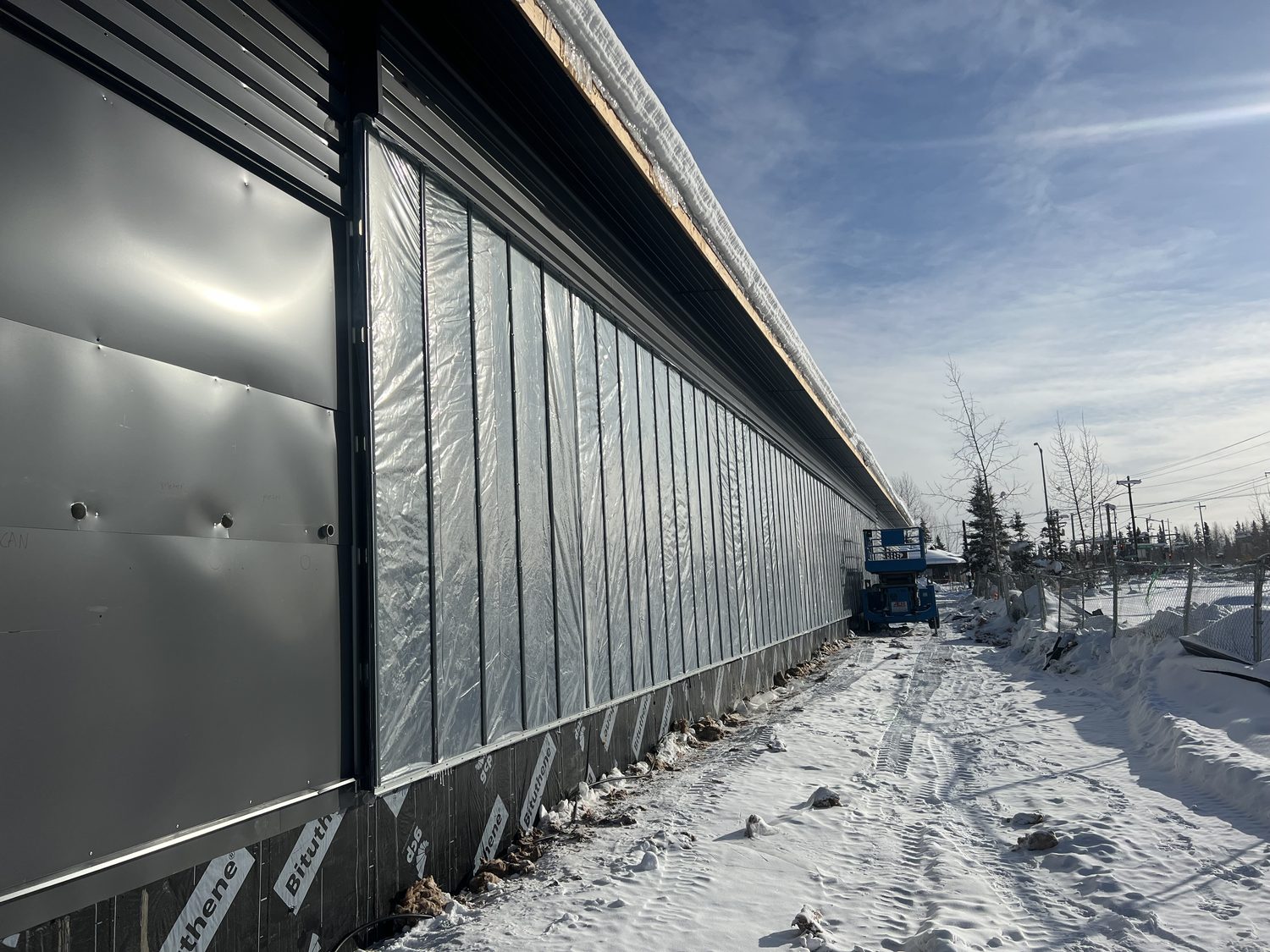 Solar wall under construction on the building exterior to reduce energy costs