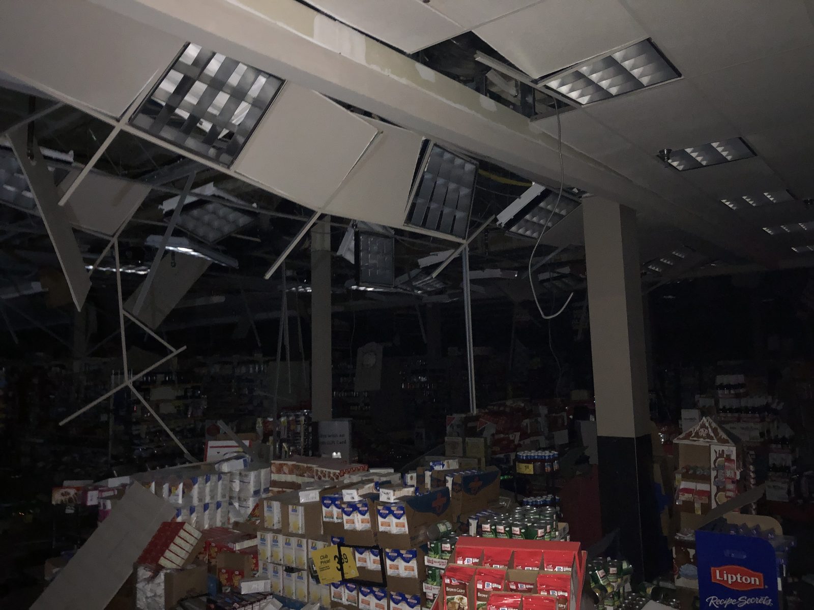Collapsed suspended ceiling hanging into a darkened Safeway store after the 2018 Alaska earthquake